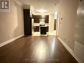 Markham (Commerce Valley) condo for rent - A spacious kitchen with dark wood floors and white walls.