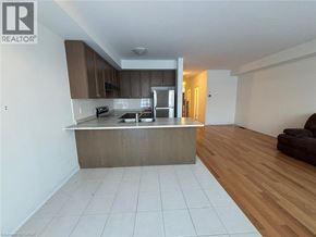 Thorold townhouse for rent - A kitchen with a wooden floor and white tiled floor.