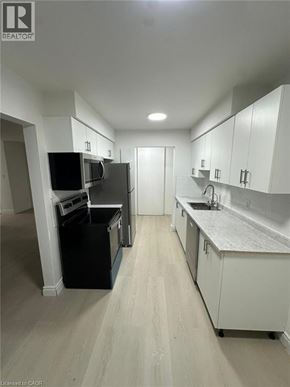 Waterloo apartment for rent - A kitchen with white cabinets and a grey counter top.
