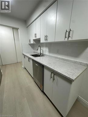 Waterloo apartment for rent - A long hallway with a refrigerator on the left.
