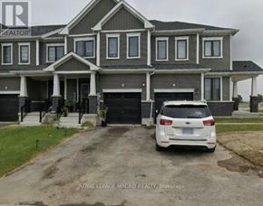 Thorold (Allanburg/Thorold South) townhouse for rent - A white car is parked in front of a grey house.
