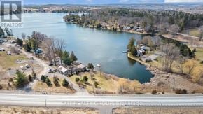 Quinte West (Sidney Ward) house for rent - A brochure image of a lake surrounded by houses.
