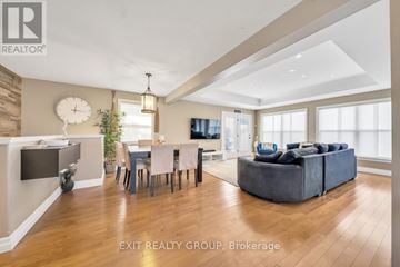 Quinte West (Sidney Ward) house for rent - A well-lit living room with a dining table and a couch.