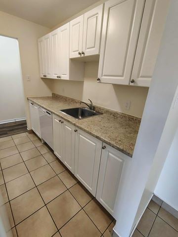 Halifax apartment for rent - A kitchen with white cabinets and a granite countertop.