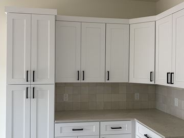 Prescott triplex for rent - A kitchen with white cabinets and drawers.