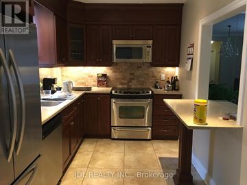 Toronto (Forest Hill South) house for rent - A kitchen with a stove top oven and microwave above it.