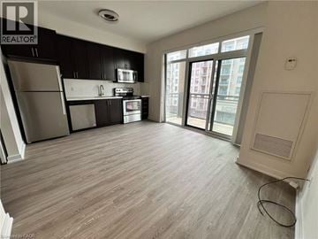 Oakville condo for rent - A kitchen with black cabinets and stainless steel appliances.