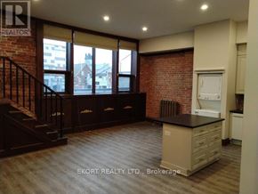 Belleville (Belleville Ward) house for rent - A kitchen area with a brick wall and wooden flooring.