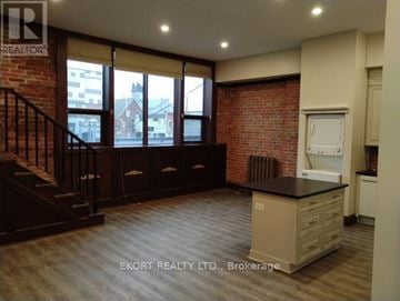 Belleville (Belleville Ward) house for rent - A kitchen area with a brick wall and wooden flooring.