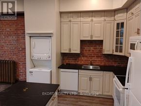 Belleville (Belleville Ward) house for rent - A kitchen with white appliances and a brick wall.