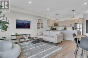Wellington North (Mount Forest) multi-family for rent - A modern living room with a white sofa, a grey armchair, and a coffee table.