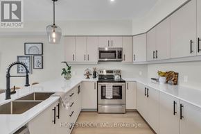 Wellington North (Mount Forest) multi-family for rent - A modern kitchen with white cabinets and stainless steel appliances.