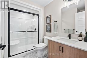 Brockton multi-family for rent - A modern bathroom with a walk-in shower and a toilet.