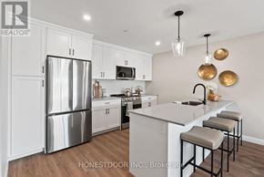Brockton multi-family for rent - A modern kitchen with white cabinets and a stainless steel refrigerator.