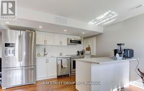 East Gwillimbury (Queensville) house for rent - A modern kitchen with a refrigerator, cabinets, and a countertop.