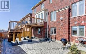 East Gwillimbury (Queensville) house for rent - A red brick house with a wooden deck and a BBQ grill.
