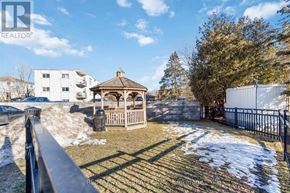 Kitchener condo for rent - A gazebo sits in a snowy yard.