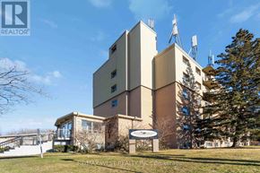 Kitchener condo for rent - A building with a sign that says REALTOR in front of it.