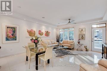 Ottawa triplex for rent - A living room with a glass dining table and chairs.