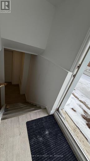 Richmond Hill (Crosby) house for rent - A hallway with a mat on the floor leading to a staircase.