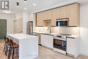 Lincoln (Beamsville) multi-family for rent - A modern kitchen with wooden cabinets and stainless steel appliances.