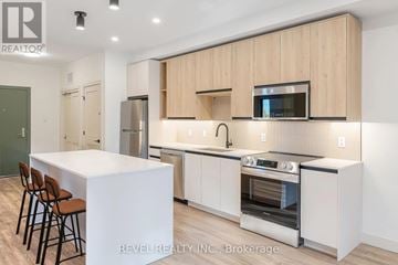 Lincoln (Beamsville) multi-family for rent - A modern kitchen with wooden cabinets and stainless steel appliances.