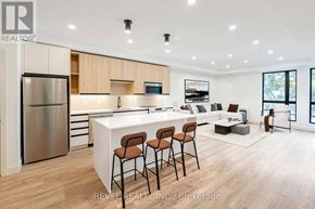 Lincoln (Beamsville) multi-family for rent - A modern kitchen with wooden cabinets and a white island.
