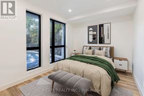 Lincoln (Beamsville) multi-family for rent - A bedroom with a bed, a bench, and a window overlooking a snowy landscape.