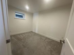 Surrey house for rent - A room with a window and a door.