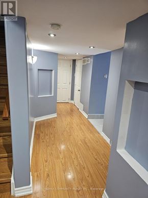 Toronto (Rouge) house for rent - A hallway with wood flooring and blue walls.