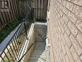 Toronto (Rouge) house for rent - A stairway with a metal railing leads down to a concrete basement.