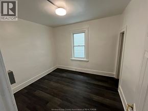 Windsor house for rent - A room with a window and wooden flooring.