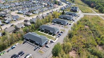 Moncton apartment for rent - A large building with a parking lot in front of it.