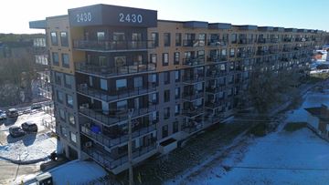 Moncton apartment for rent - Apartment building 2430 with cars parked in front.
