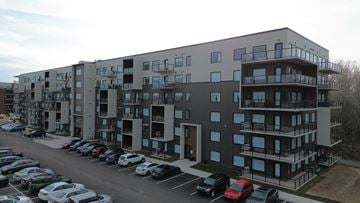 Moncton apartment for rent - A parking lot in front of a multi-story apartment building.