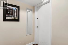 Ottawa triplex for rent - A white door is in a room with a framed picture of a bicycle on the wall.