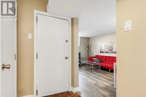 Ottawa triplex for rent - A white door is open to a room with a red couch.