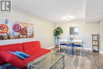 Ottawa triplex for rent - A living room with a red couch and a glass coffee table.