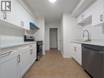 Windsor townhouse for rent - A kitchen with white cabinets and a stainless steel dishwasher.