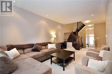 East Gwillimbury townhouse for rent - A living room with a brown couch and a black coffee table.