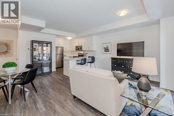 Kitchener townhouse for rent - A modern living room with a white sofa and a glass coffee table.