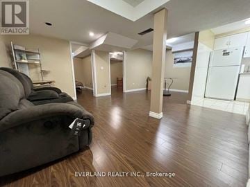 Markham (Cedarwood) house for rent - A living room with a couch and a chair in it.