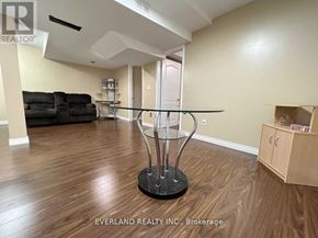 Markham (Cedarwood) house for rent - A room with a glass table and a black sofa.