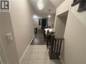 Hamilton townhouse for rent - A hallway with a light on and a door at the end.