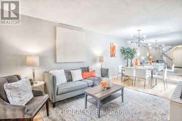 Ajax (Central West) house for rent - A living room with a grey couch and a coffee table.