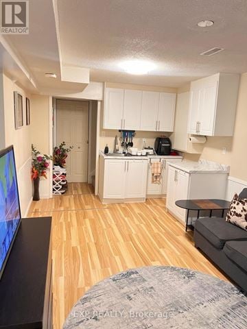 Ajax (Central West) house for rent - A living room with a grey couch and a television.