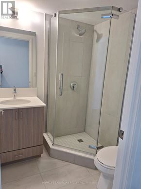 Barrie (Alliance) condo for rent - A bathroom with a walk in shower and a toilet.
