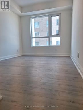 Barrie (Alliance) condo for rent - A room with wooden flooring and a large window.