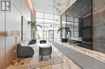 Vaughan (East Woodbridge) condo for rent - A modern living room with a grey sofa and a wooden floor.