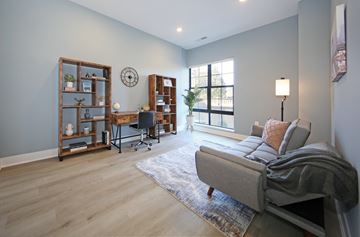 South Orange apartment for rent - A living room with a grey couch and a wooden bookshelf.